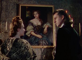 Movie still from “Saraband” (1948), directed by Basil Dearden – A man and a woman standing in front of a painting; Medium shot, Over the shoulder angle