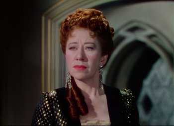 Movie still from “Saraband” (1948), directed by Basil Dearden – A person wearing a dress; Close Up shot, Over the shoulder angle