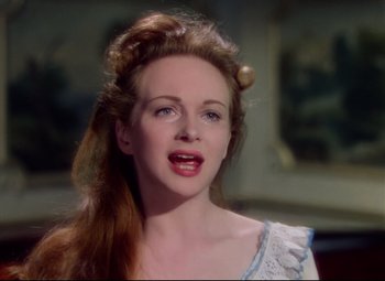 Movie still from “Saraband” (1948), directed by Basil Dearden – A beautiful woman with red hair and blue eyes; Close Up shot, Over the shoulder angle