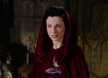 Movie still from “Saraband” (1948), directed by Basil Dearden – A woman wearing a red cape and a purple dress; Close Up shot, High angle