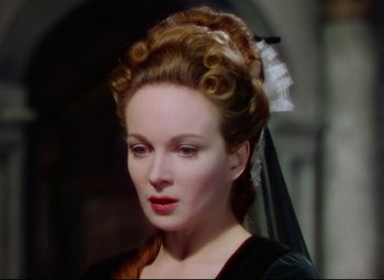 Movie still from “Saraband” (1948), directed by Basil Dearden – A person wearing a dress; Close Up shot, Over the shoulder angle