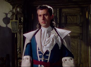 Movie still from “Saraband” (1948), directed by Basil Dearden – A man dressed as a man in a costume; Medium shot, Over the shoulder angle