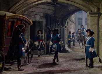 Movie still from “Saraband” (1948), directed by Basil Dearden – A group of men in period costume standing in a courtyard; Wide shot, High angle