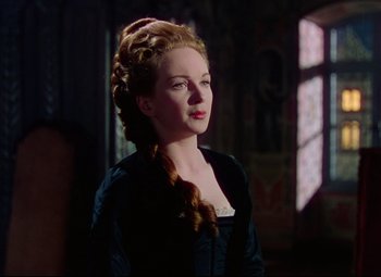 Movie still from “Saraband” (1948), directed by Basil Dearden – A woman in a black dress with long blonde hair; Close Up shot, Over the shoulder angle