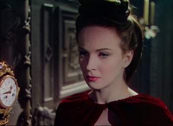 Movie still from “Saraband” (1948), directed by Basil Dearden – A woman in a red dress looking to her left; Close Up shot, Over the shoulder angle