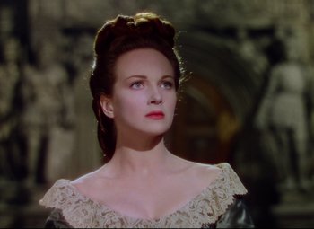 Movie still from “Saraband” (1948), directed by Basil Dearden – A woman in a white dress looking to her left; Close Up shot, Low angle