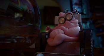 Movie still from “Sausage Party” (2016), directed by Greg Tiernan – A pink pig sitting on top of a wooden table next to a fish bowl; Wide shot, High angle