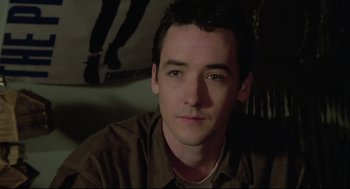 Movie still from “Say Anything” (1989), directed by Cameron Crowe – A person wearing a brown shirt; Close Up shot, High angle