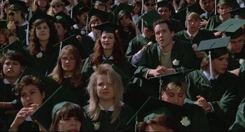 Movie still from “Say Anything” (1989), directed by Cameron Crowe – A large group of people in graduation caps and gowns; Medium shot, High angle