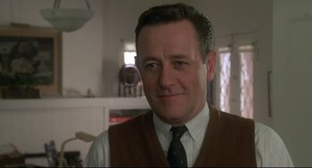 Movie still from “Say Anything” (1989), directed by Cameron Crowe – A person wearing a vest and a tie; Close Up shot, Low angle