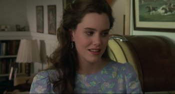 Movie still from “Say Anything” (1989), directed by Cameron Crowe – A woman with long brown curly hair wearing a blue dress; Close Up shot, Over the shoulder angle