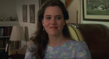 Movie still from “Say Anything” (1989), directed by Cameron Crowe – A woman with long brown hair wearing a blue floral dress; Close Up shot, Over the shoulder angle