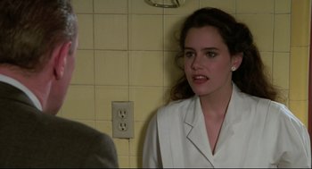 Movie still from “Say Anything” (1989), directed by Cameron Crowe – A woman in a white jacket talking to a man in a suit; Close Up shot, Over the shoulder angle