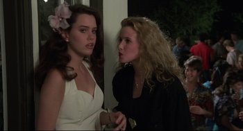 Movie still from “Say Anything” (1989), directed by Cameron Crowe – Two young women standing next to each other talking; Medium shot, Over the shoulder angle