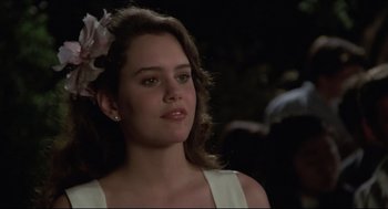 Movie still from “Say Anything” (1989), directed by Cameron Crowe – A woman with a flower in her hair looking to her left; Close Up shot, Over the shoulder angle