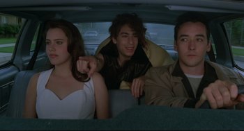 Movie still from “Say Anything” (1989), directed by Cameron Crowe – A group of people sitting in the back of a car; Medium shot, Over the shoulder angle