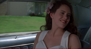 Movie still from “Say Anything” (1989), directed by Cameron Crowe – A woman sitting in the back seat of a car; Close Up shot, Over the shoulder angle