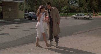 Movie still from “Say Anything” (1989), directed by Cameron Crowe – A man and a woman walking down a sidewalk; Wide shot, Low angle