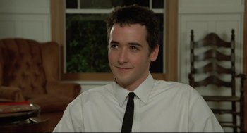Movie still from “Say Anything” (1989), directed by Cameron Crowe – A man in a white shirt and a black tie; Close Up shot, Low angle