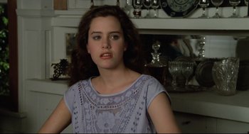 Movie still from “Say Anything” (1989), directed by Cameron Crowe – A woman in a blue dress is sitting in front of a fire place; Close Up shot, Over the shoulder angle