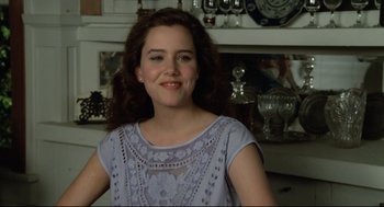 Movie still from “Say Anything” (1989), directed by Cameron Crowe – A woman in a blue dress smiling for the camera; Close Up shot, Over the shoulder angle