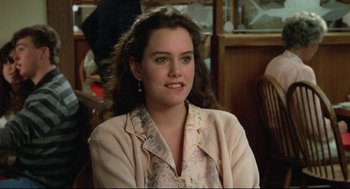 Movie still from “Say Anything” (1989), directed by Cameron Crowe – A young woman sitting in front of a window; Close Up shot, Over the shoulder angle