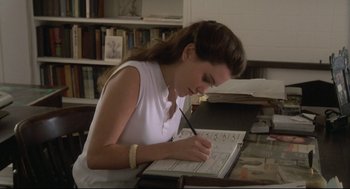 Movie still from “Say Anything” (1989), directed by Cameron Crowe – A woman is writing in a book at a desk; Medium shot, High angle
