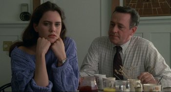 Movie still from “Say Anything” (1989), directed by Cameron Crowe – A man and a woman sitting at a dinner table; Close Up shot, Over the shoulder angle