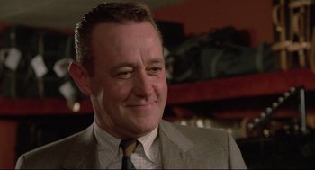 Movie still from “Say Anything” (1989), directed by Cameron Crowe – A person wearing a suit and tie; Close Up shot, Low angle