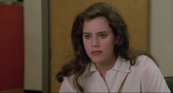 Movie still from “Say Anything” (1989), directed by Cameron Crowe – A woman with long brown hair wearing a white dress shirt; Close Up shot, Over the shoulder angle