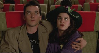 Movie still from “Say Anything” (1989), directed by Cameron Crowe – A man and a woman sitting next to each other; Close Up shot, Low angle