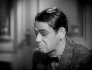 Movie still from “Scarface” (1932), directed by Richard Rosson – An old photo of a man in a plaid jacket; Close Up shot, High angle