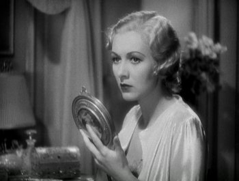Movie still from “Scarface” (1932), directed by Richard Rosson – A black and white photo of a woman looking at a mirror; Close Up shot, High angle