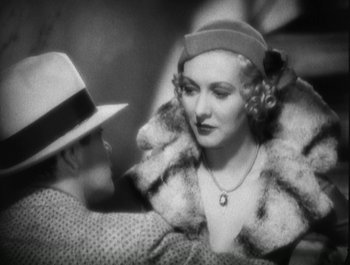 Movie still from “Scarface” (1932), directed by Richard Rosson – An old photo of a man and a woman; Close Up shot, Over the shoulder angle