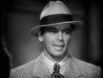 Movie still from “Scarface” (1932), directed by Richard Rosson – A black and white photo of a man wearing a hat and a tie; Close Up shot, High angle