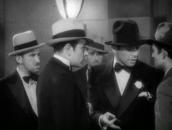 Movie still from “Scarface” (1932), directed by Richard Rosson – A black and white photo of a group of men in suits and hats; Medium shot, High angle