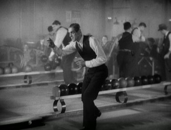 Movie still from “Scarface” (1932), directed by Richard Rosson – An old photo of a man in a dress shirt and tie; Medium shot, High angle