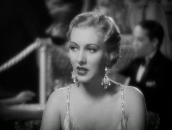 Movie still from “Scarface” (1932), directed by Richard Rosson – An old photo of a woman in a dress; Close Up shot, Over the shoulder angle