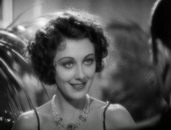 Movie still from “Scarface” (1932), directed by Richard Rosson – An old black and white photo of a woman in a dress; Close Up shot, High angle