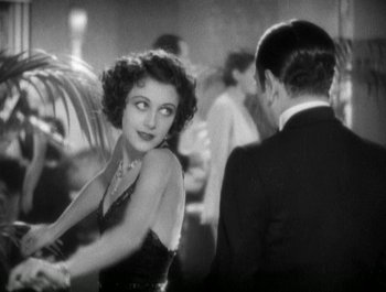 Movie still from “Scarface” (1932), directed by Richard Rosson – An old photo of a woman and a man dancing; Medium shot, Over the shoulder angle