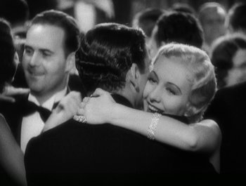 Movie still from “Scarface” (1932), directed by Richard Rosson – A black and white photo of a man and a woman hugging; Close Up shot, High angle