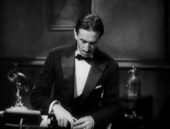 Movie still from “Scarface” (1932), directed by Richard Rosson – A black and white photo of a man in a tuxedo; Medium shot, High angle