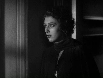 Movie still from “Scarface” (1932), directed by Richard Rosson – An old photo of a woman looking out of a window; Close Up shot, Low angle