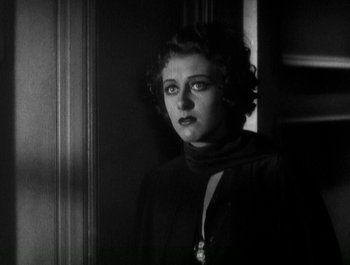 Movie still from “Scarface” (1932), directed by Richard Rosson – An old photo of a woman in a dark room; Close Up shot, Low angle