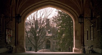 Movie still from “Scent of a Woman” (1992), directed by Martin Brest – An archway leading to a building with trees in the background; Extreme Wide shot, High angle
