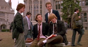 Movie still from “Scent of a Woman” (1992), directed by Martin Brest – A group of young men sitting next to each other on a bench; Medium shot, Low angle