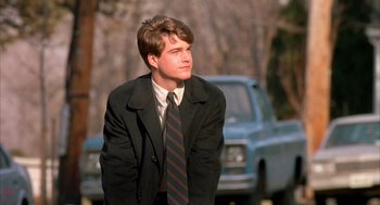 Movie still from “Scent of a Woman” (1992), directed by Martin Brest – A man in a suit and tie standing in front of a truck; Medium shot, Low angle