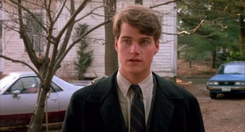 Movie still from “Scent of a Woman” (1992), directed by Martin Brest – A man in a suit and tie standing in front of a car; Close Up shot, Over the shoulder angle