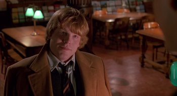 Movie still from “Scent of a Woman” (1992), directed by Martin Brest – A man in a suit and tie in front of a wooden table; Medium shot, High angle