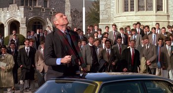 Movie still from “Scent of a Woman” (1992), directed by Martin Brest – A crowd of people standing around a man in a suit and tie; Medium shot, Low angle